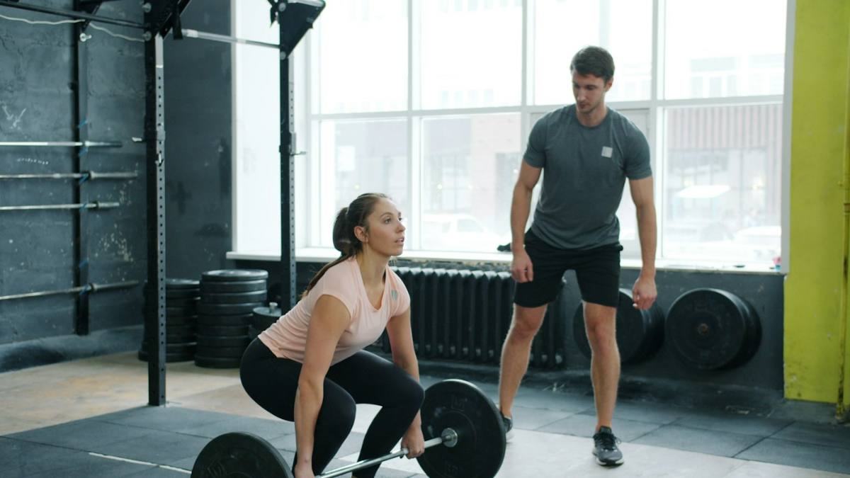 Personal trainer coaching a client